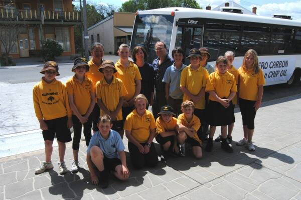 CLEAN ENERGY: Gunning engineer Ned Stojadinovic and Green Upper Lachlan Project manager Sarah Bucknell with some of the local primary school students who will benefit from their town’s new biodiesel bus.