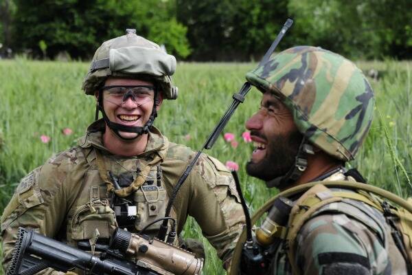 LIGHTER MOMENT: Goulburn man Lieutenant Geoff Godkin shares a joke with Afghan National Army Commander Lieutenant Naeer Ahmad.in the village of Kararak in central Afghanistan. Photo: Sergeant Mick Davis, ADF.
