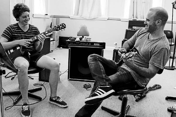ROCKING OUT: 14-year-old guitar student Zac Hannan finger tapping with his teacher Luke Wheeldon.