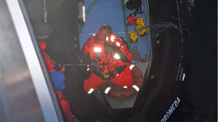 Safe and sound ... Ice pilot Tim Sharpe holds rescued sailor Alain Delord.