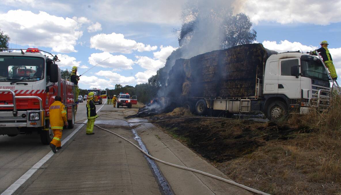 A truck carrying hay caught fire along the Goulburn Bypass section of the Hume Highway at around 1.00pm this afternoon. Photo DARRYL FERNANCE. 