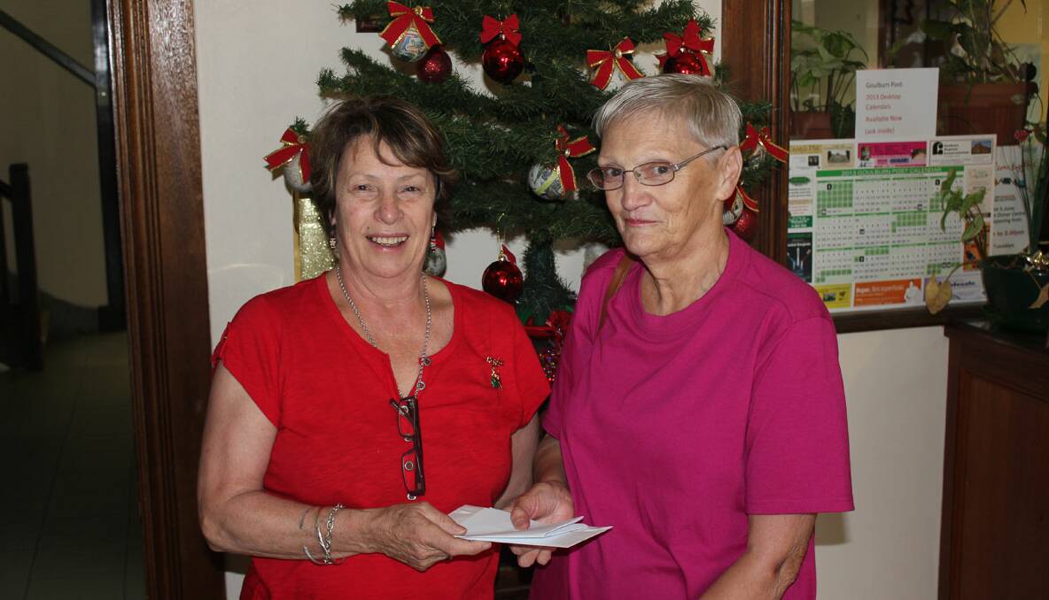 Mrs Hogan is pictured at the draw with Goulburn Post manager Helen Esson.