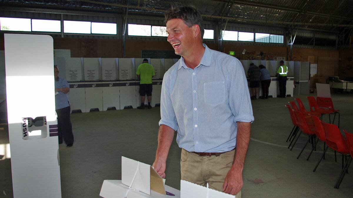 New member for Hume, Angus Taylor finished the last bit of paperwork for his campaign when he voted at the Scout Hall booth in Goulburn on Saturday afternoon. Photo DARRYL FERNANCE - Goulburn Post.
