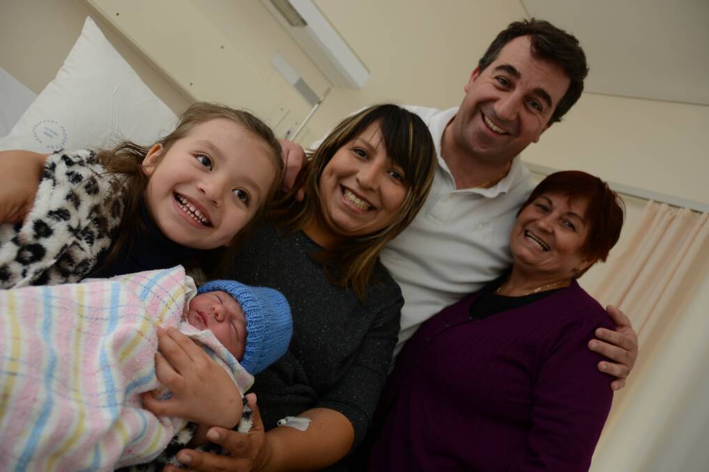 Baby Phillipe, born at Manning Hospital in Taree, pictured with happy sister Daniella, proud parents Paul and Ileana Stathis and grandmother Berta Ortega
