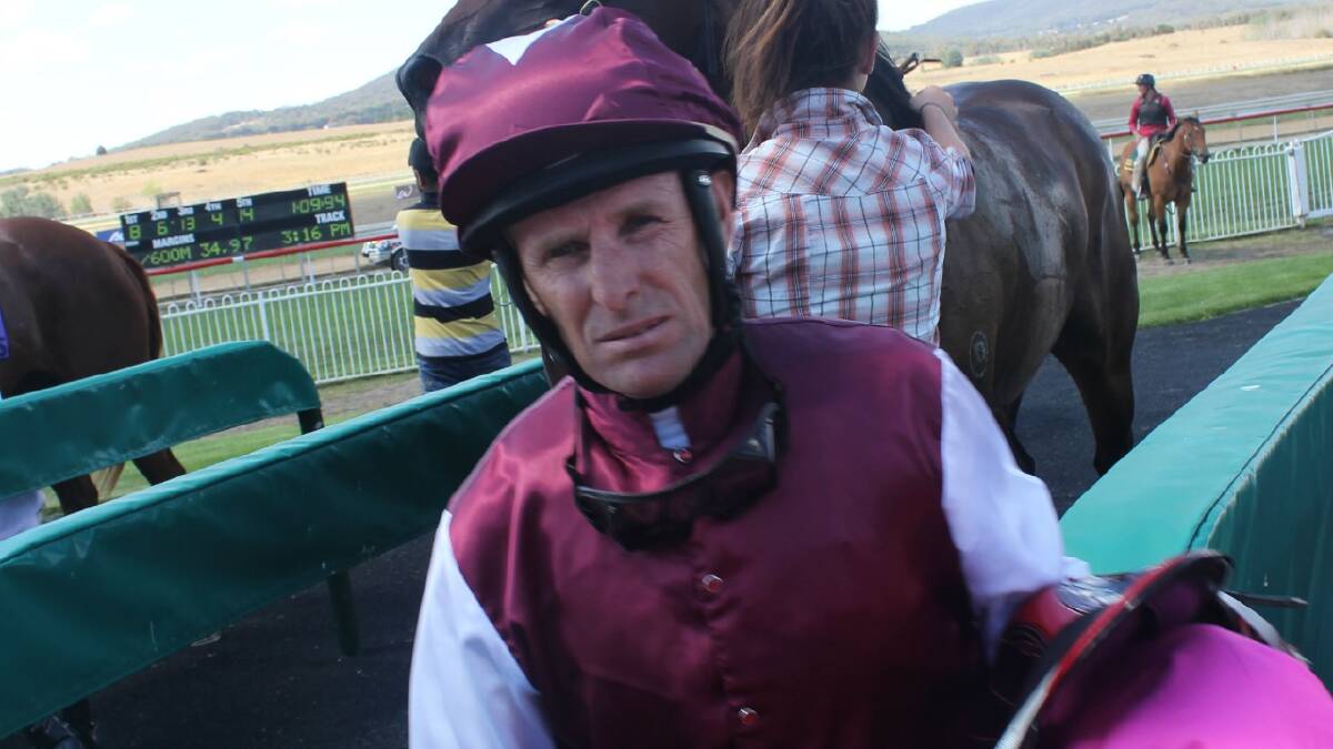 Jockey Rod Quinn heads for a debrief with Guy Walter after riding Ameliorate to race four victory.