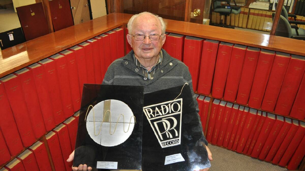   LONG CAREER: Veteran journalist and longtime Goulburn Post columnist Ray Williams poses with a couple of Australian Radio ‘News Commentator’ awards he won in 1979 and 1980. Mr Williams has been in the media game for more than 70 years. 