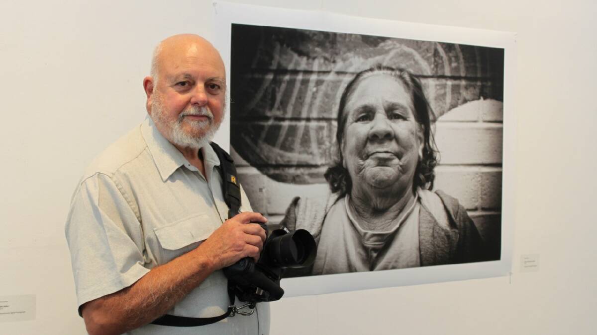 SHINING A LIGHT: Local photographer and proud Wiradjuri man Perc Carter standing next to his portrait of indigenous elder Evelyn Little or Aunty Evelyn as she is better known. The photograph is currently on display at the Goulburn Regional Art Gallery as part of the Marrambang Meeting Place exhibition.