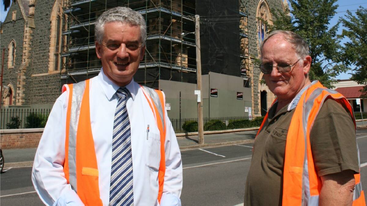ON THE UP: Architect Garry Dutaillis and Ss Peter and Paul’s Old Cathedral restoration committee member Brian Watchirs are looking forward to completion of the structure’s spire. The work has been delayed by several months.