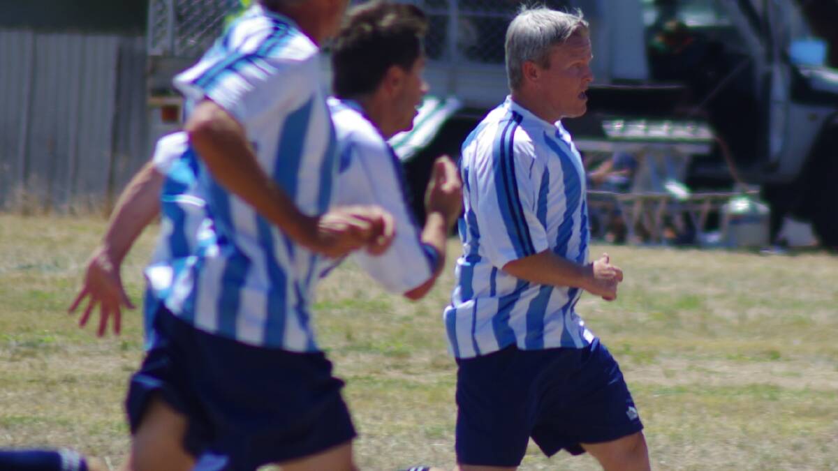  GOULBURN’S OLD HANDS: Hats (Highland and Tablelands Soccer) Blue player Eric Young barnstorms down the pitch.  Photo: Darryl Fernance.
