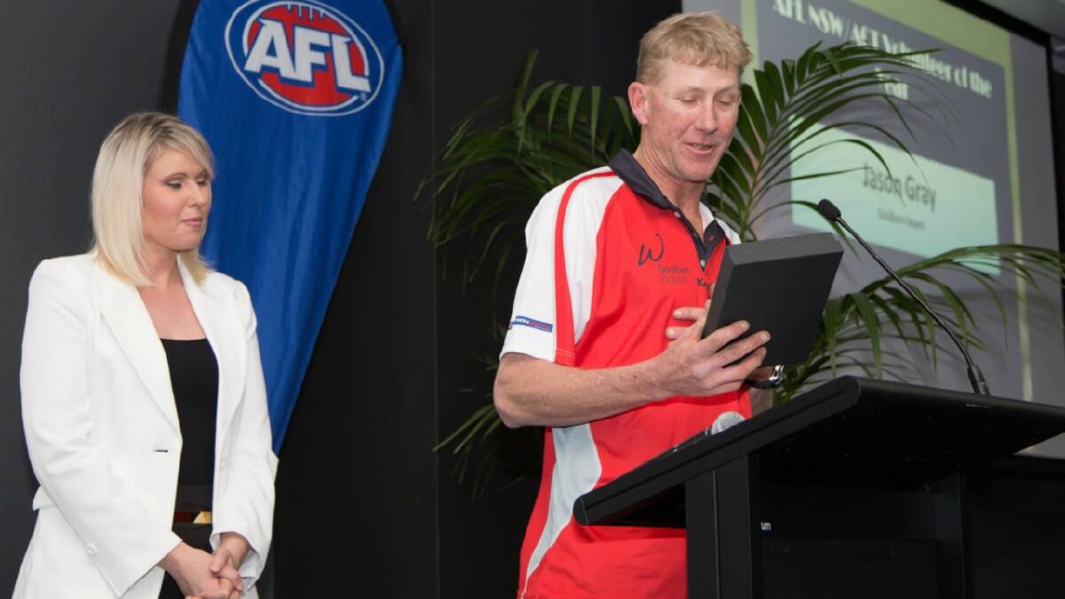   HERE’S TO YOU: Jason Gray (above, right) accepts AFL Canberra’s Junior Volunteer of the Year Award. Photo: Ben Southall.