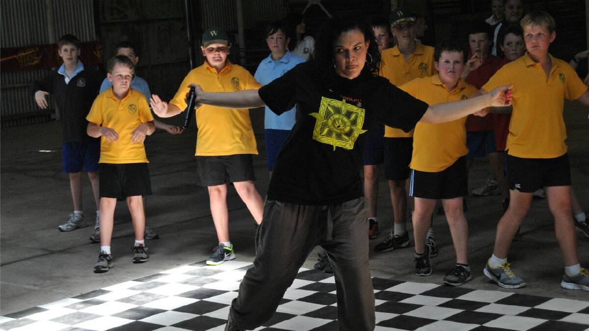 MOVES: Vibe Sydney break-dancing performer and teacher Jacqui Cornforth demonstrates a move to some of the kids from Wollondilly Public School.