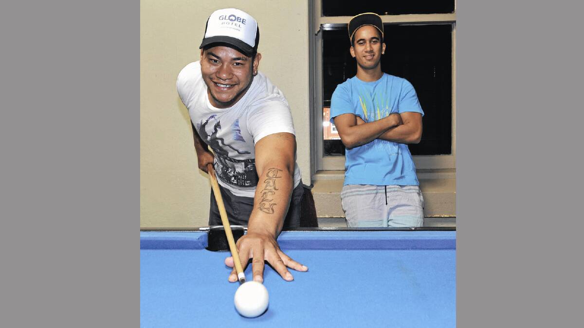 Cootamundra’s newest recruit, Talia’Uli Takitaki, contemplates the Group Nine season over a game of pool with his mate John Matapo at the Globe Hotel in Cootamundra yesterday. Picture: Les Smith