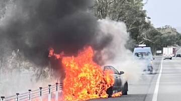 A car erupted in flames on the Hume Highway on Thursday afternoon. Picture by RFS.