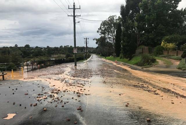 May Street in Goulburn was awash with mud, silt and rocks from a subdivision on the corner of Chiswick Street, following Saturday's torrential rain. Photo: Heather West. 