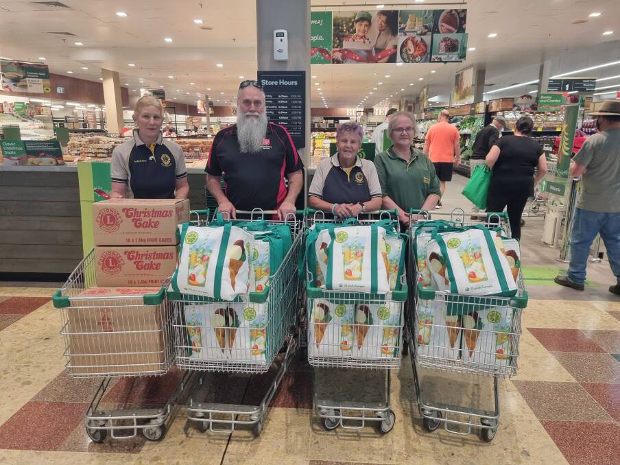 L to R: Maureen Strong (Lions), Major Phillip McCall (Salvation Army), Prue Rickard (Lions) and Ruth Doggett (Can Assist) with the hampers. Picture: Dominic Unwin