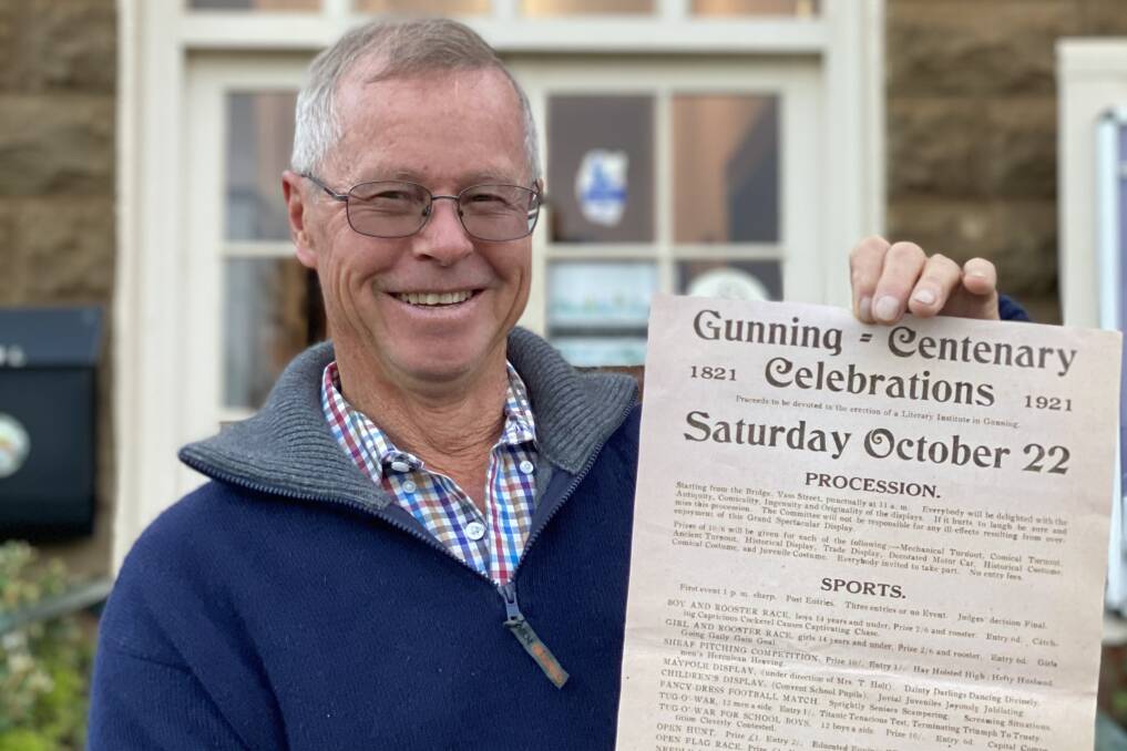 Chairman of the Gunning 200 co-ordinating committee John Shaw with the 1921 centenary celebrations poster. Picture: supplied