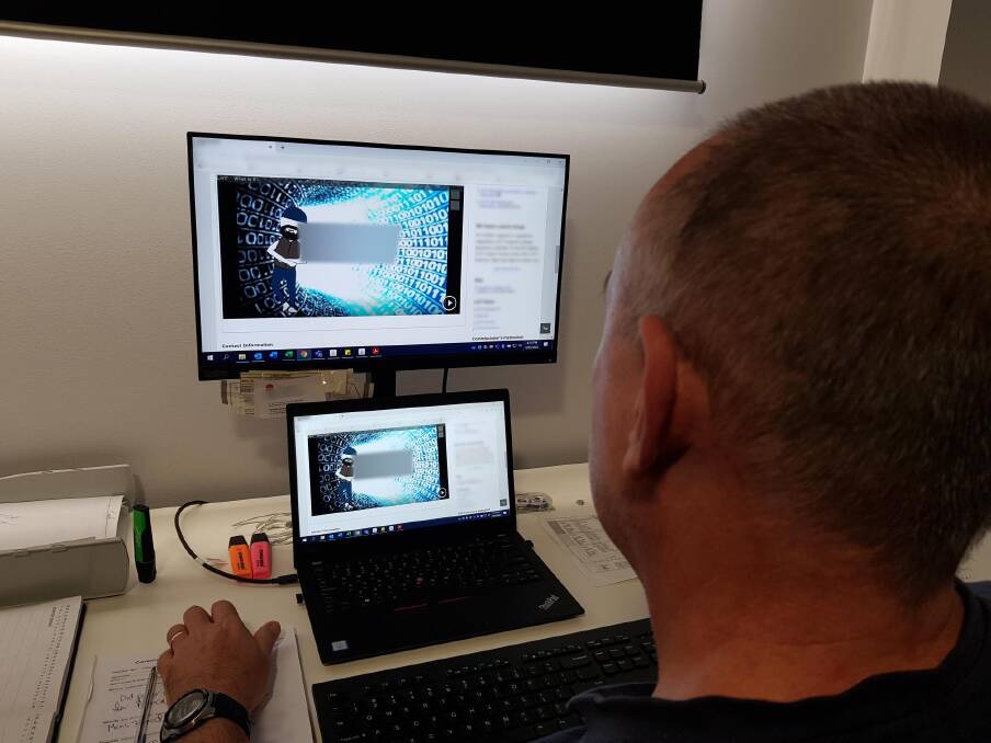 A Community Corrections officer using a laptop to work remotely with offenders on programs. Photo: Corrective Services NSW