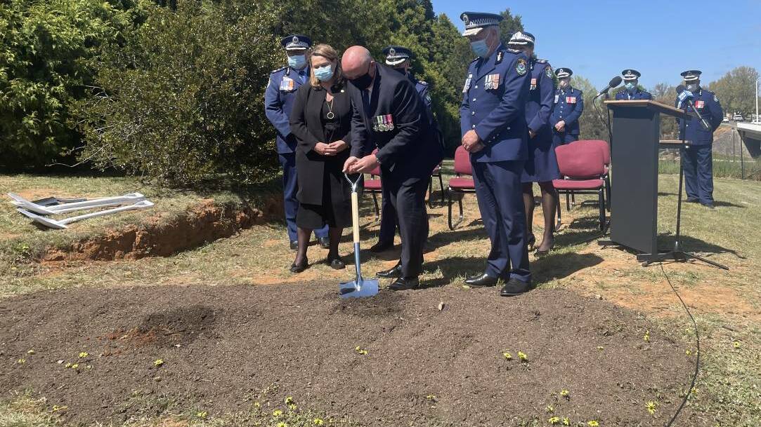  Dig: Minister for Police and Emergency Services David Elliott turns over the first sod at the location of the new Goulburn Police Station. Photo: Burney Wong.