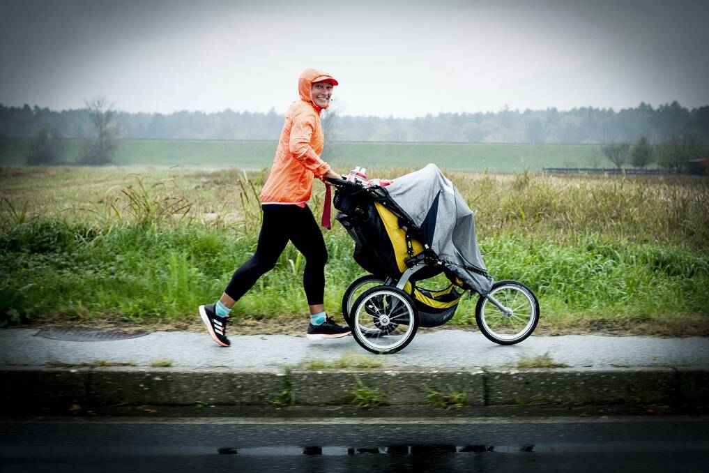 Marie Leautey pushing her 30kg BoB (Beast of Burden) Ironman stroller through the rain in Slovenia. Photo by Ana Kovac