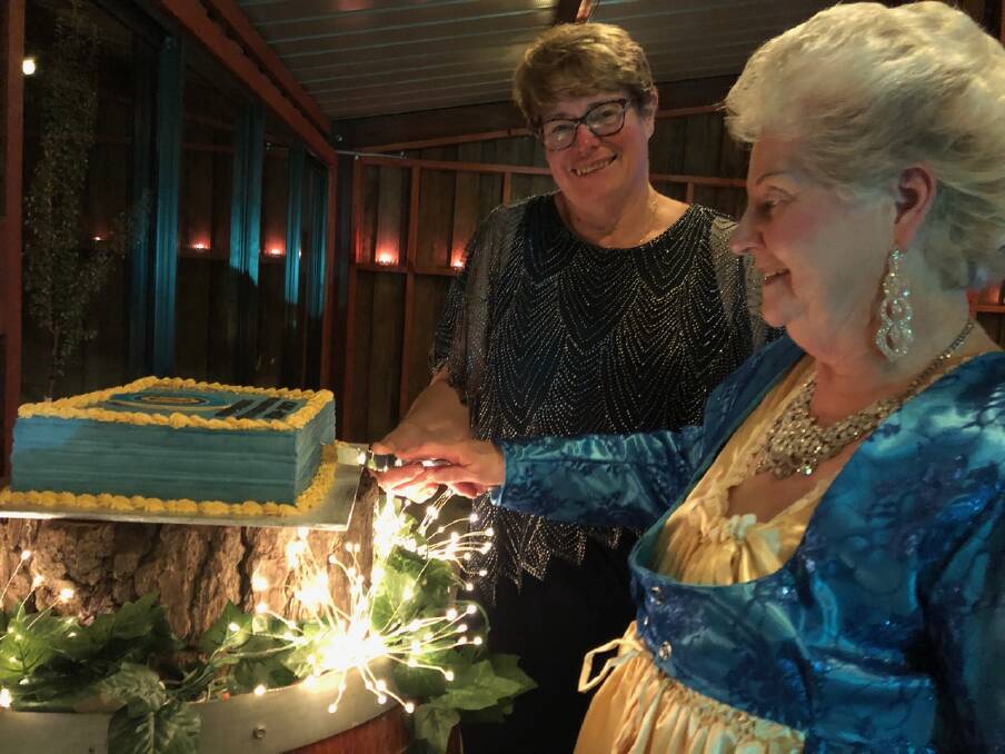 Cutting the cake at the CWA Blue and Gold Ball. Photo: Supplied.