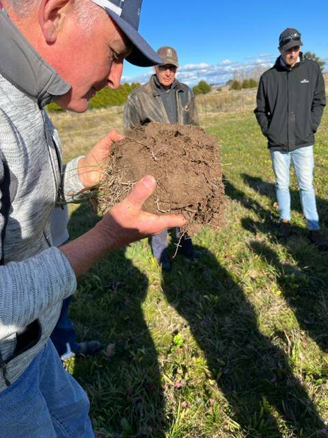 Inspecting the soil health at Craig Hunt's trial paddock. Photo: Supplied.
