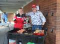 Jess Webster and Ben Williams serving up democracy sausages at the P&C BBQ at Goulburn West Public School. Photo: Sophie Bennett. 