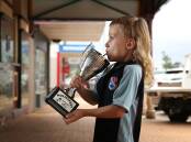Max Johnson, 6, taking a sip from the the Best Mullet Of Them All trophy. Picture: Simone De Peak.