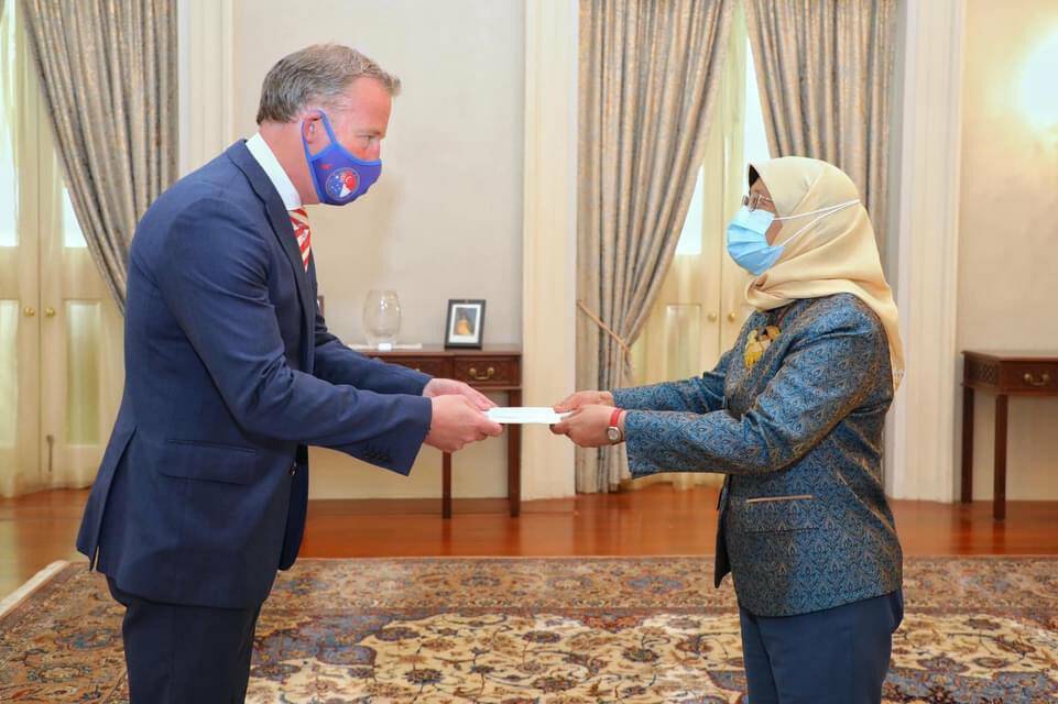 In the days after posting the video, Will Hodgman posted this image three times of him handing his credentials to Singapore president Halimah Yacob.