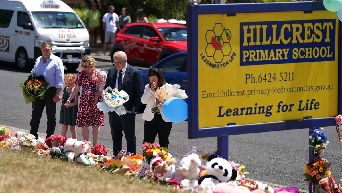 Mourning: Braddon MP Gavin Pearce and Prime Minister Scott Morrison pay their respects with family at Hillcrest Primary School.