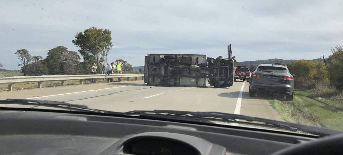 ROLL OVER: A truck has rolled over on the Hume Highway near Collector. Photo: David Cole.