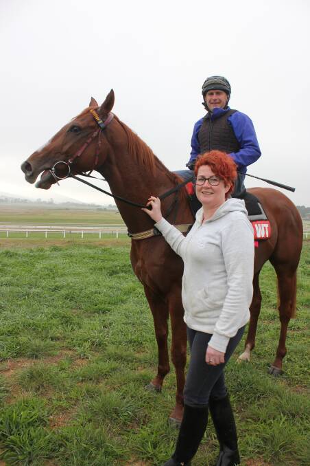 COUNTRY HEART: Kylie Wheeler stands next to  Pentathlon and Patrick Murphy in the lead-up to the Sydney Cup on Saturday. Pentathlon had his final gallop in Goulburn.