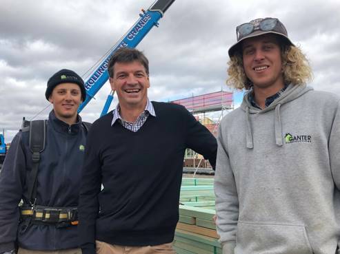 GROWTH: Member for Hume Angus Taylor is pictured with Sam and James Toparis at the Marys Mount construction site in Goulburn. Photo: supplied.