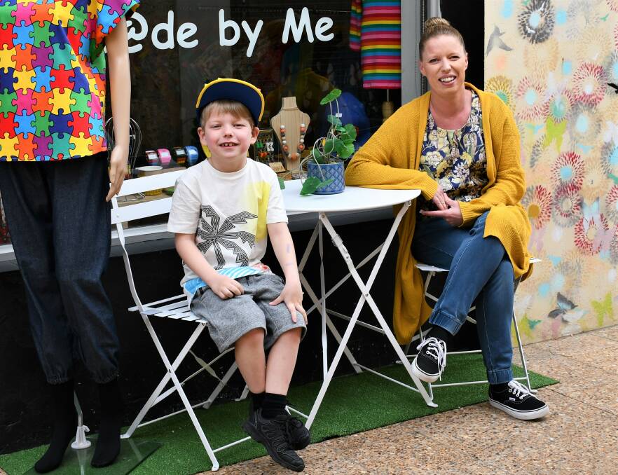 HANDMADE: Kylie Walsh with her son Elijah outside their clothing store. Photo: Hannah Neale