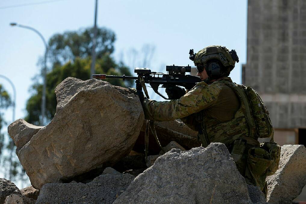 COMBAT TRAINING: Corporal John Mitchell keeps watch for the enemy during urban combat training in Singleton. Photo: Australian Defence Force