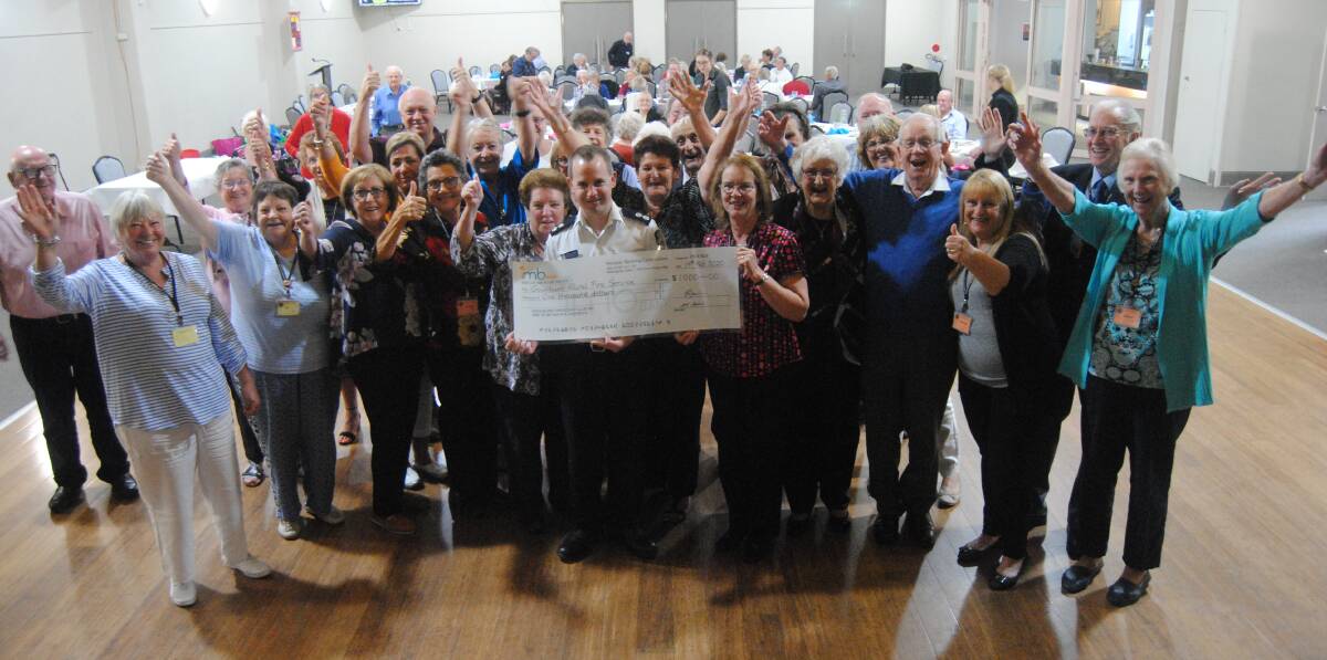 CHEQUE THIS OUT: Operations officer Michael Gapps with members of the Goulburn Friendship Club. Photo: Ainsleigh Sheridan. 