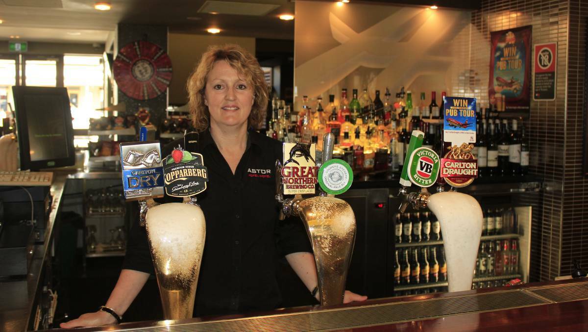 BACK TO BUSINESS: Astor Hotel owner Adrienne Griffiths ready behind the bar at the Astor Hotel. Photo: File
