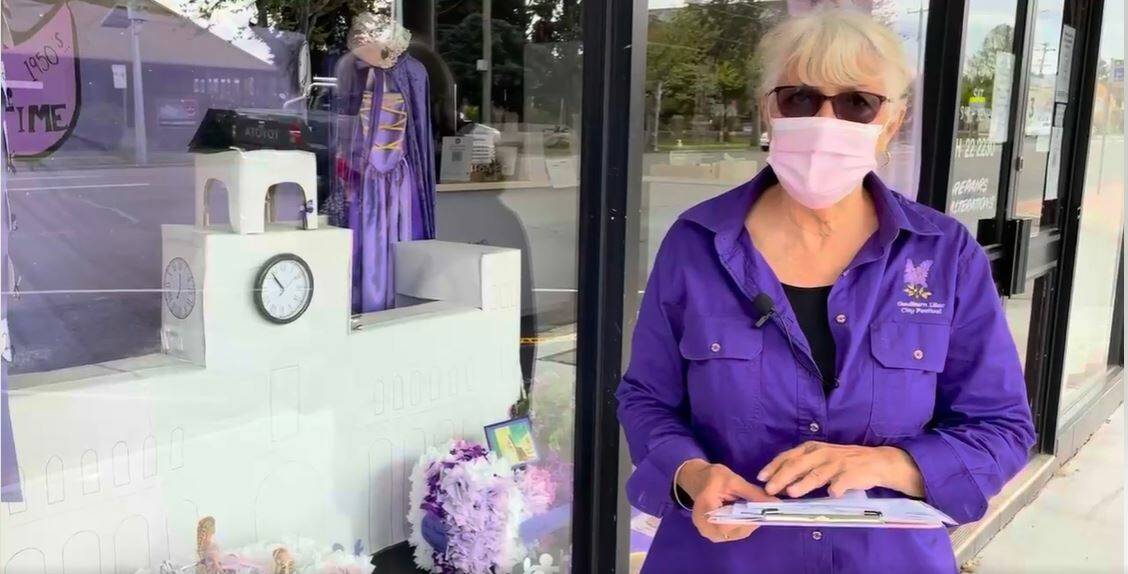 LILAC TIME: Carol James announces the window competition winners outside grand prize winner R Js Dry Cleaning. Photo: Supplied