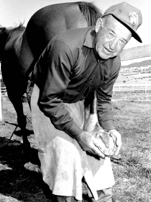 HORSEMAN: Reg Willoughby reshoeing a horse in 1997. Photo: Lyn Therry