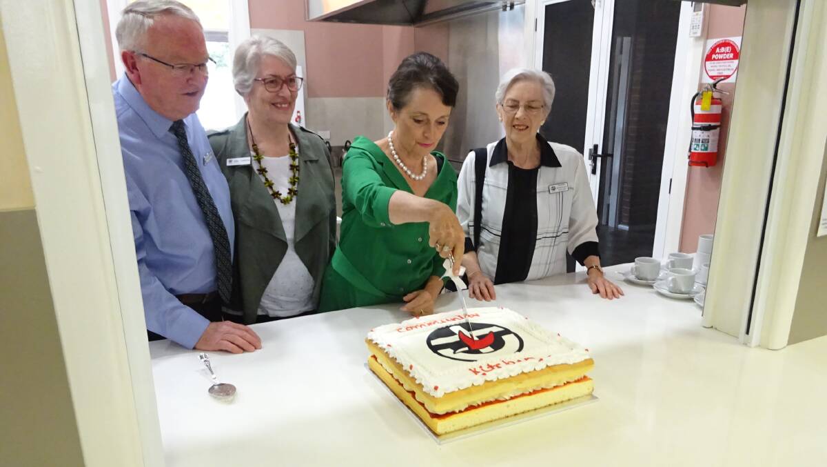 READY TO SERVE:Pru Goward MP cutting the celebratory cake watched by committee members John  and Jenny Townsend and Rosemary Miller. Photo: Supplied