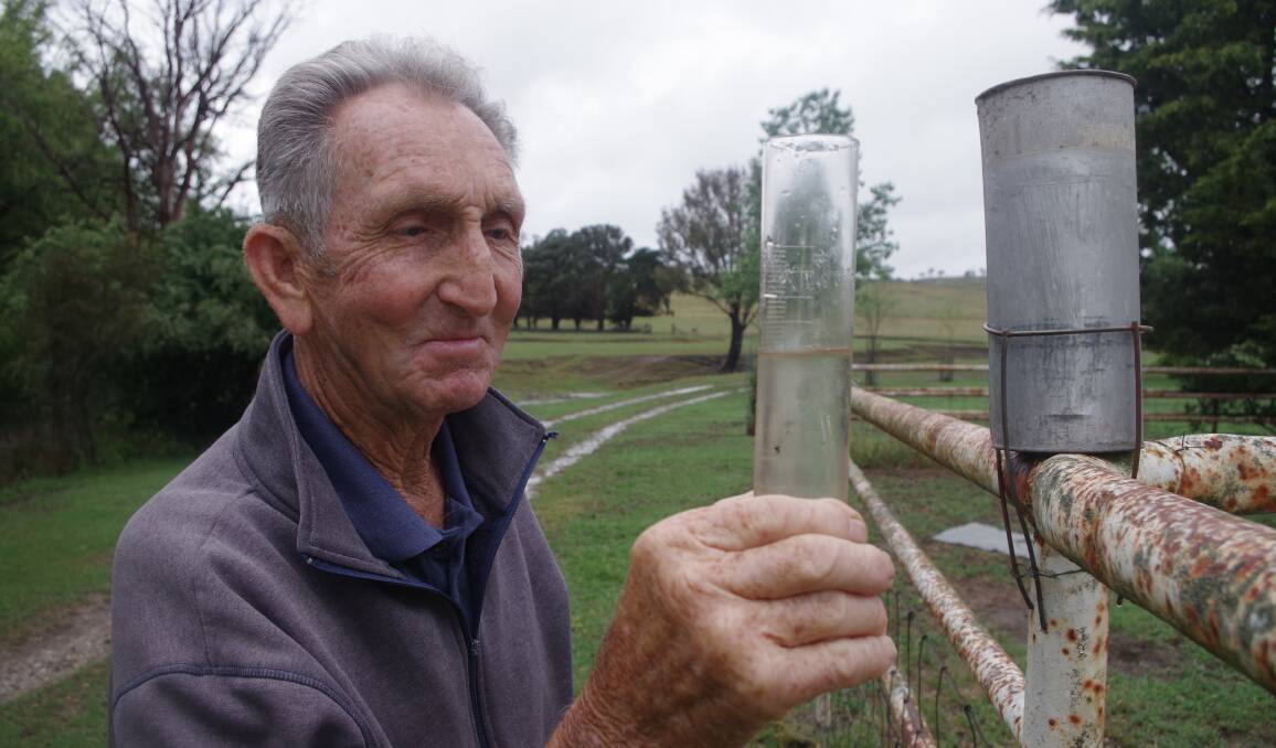 GOOD DROP: Bob Blay from Myrtleville inspects his rain gauge shortly after noon on Friday to find an additional 7.5mm of rain had fallen since 7am. Photo: Darryl Fernance