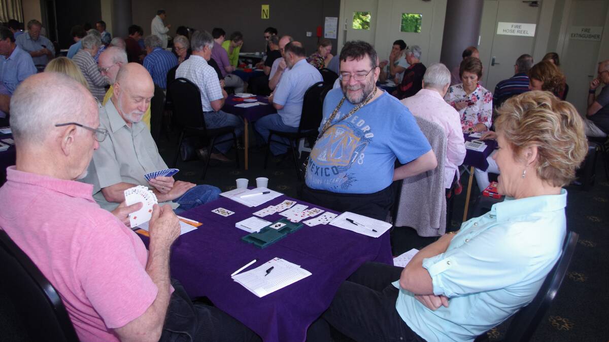 CONCENTRATING: George Riszko (left) and Richard Hill (opposite) from Canberra with Noel and Anne Marie Athea (right) during the Swiss teams bridge competition on Saturday, December 3, at the Goulburn Soldiers Club. Photo: Darryl Fernance