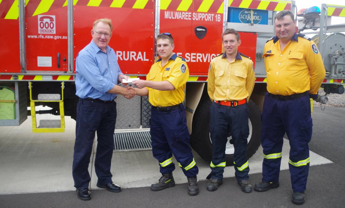 HELPING HAND: Goulburn's |Mulwaree Support Rural Fire Service representatives Riley Shiel, Dominic Gray and Captain Rodney Thistleton hand over the proceeds of their fundraising to Goulburn Mulwaree Mayor Bob Kirk. Photo: Darryl Fernance