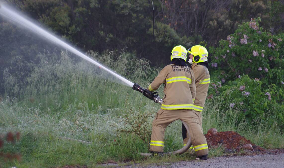 RETAINED: Two of Goulburn's retained 'on call' firefighters directing water onto the St John's Orphanage building fire on November 3, 2016. Photo: Darryl Fernance