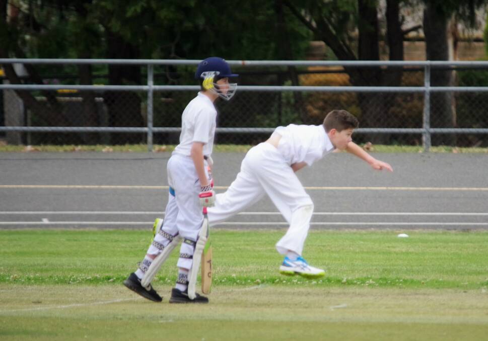 MID AIR: Wollondilly Green bowler Ryan Corliss in mid air following through on his attack with Alex Mackay from Gold off strike. Photo: Darryl Fernance