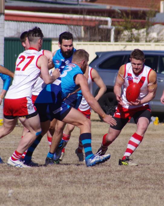 WINNING POSSESSION: Swans' Brad Smith is first to the ball in the tough encounter with Woden on Saturday July 21. Photo: Darryl Fernance