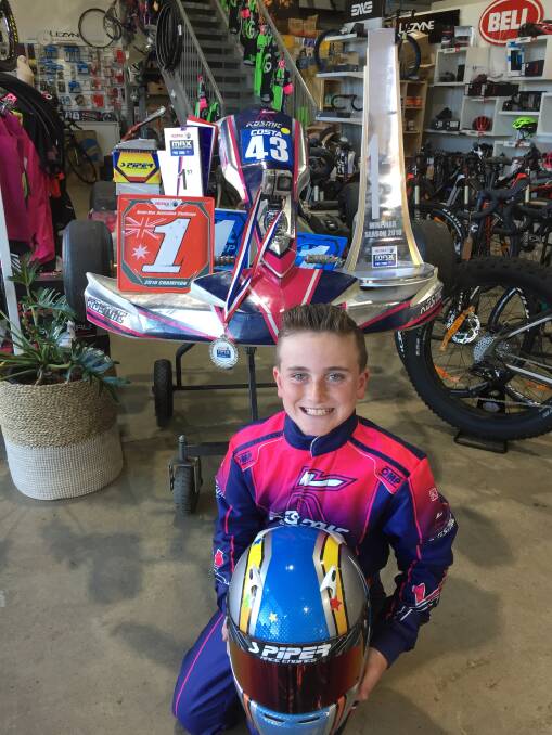 NATIONAL CHAMPION: Costa Toparis with his Rotax Kart Mini Max Australian Champion #1 plate and trophy on his kart (behind), which he raced in the first five rounds of the national competition. Photo: David Cole