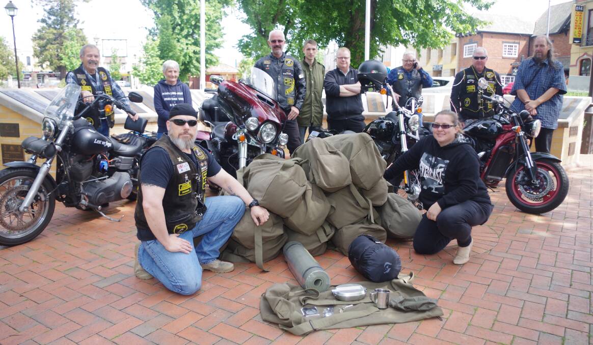 BASIC COMFORT: Southern Tablelands Veterans Motorcycle Club president Tim "Snake" Stroud with Melinda Skidmore from Angels for the Forgotten with club members and volunteers and the packs for the homeless. Photo: Darryl Fernance