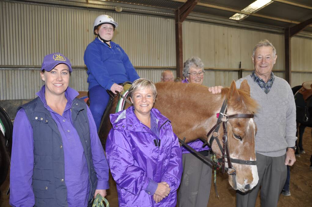 HAPPY: Goulburn Riding for Disabled coach Jo Grove, Mon aboard 'Cherry, president Kerry Guymer, volunteer Kath Cole and Robert Davey.