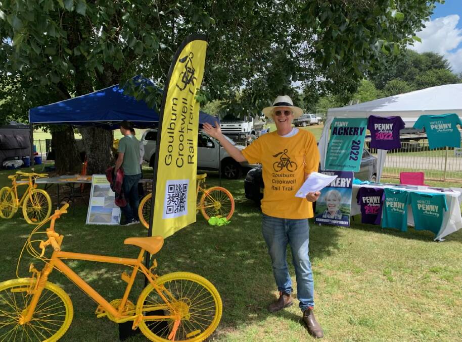 Friends of Goulburn to Crookwell Rail Trail member, McComas Taylor with one of the trademark yellow bikes designed to engage with the community about the project. Picture supplied.