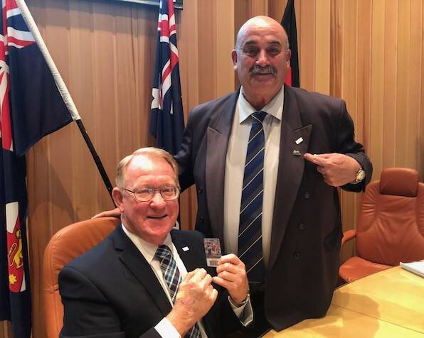 Mayor Bob Kirk and his newly elected deputy, Peter Walker proudly point to their Rabbitohs' badges at Tuesday night's council meeting. 